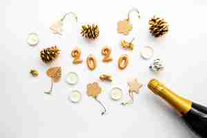 Free photo decor arrangement and champagne with 2020 new year digits