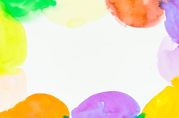 Decorated colorful watercolor blots frame on white background