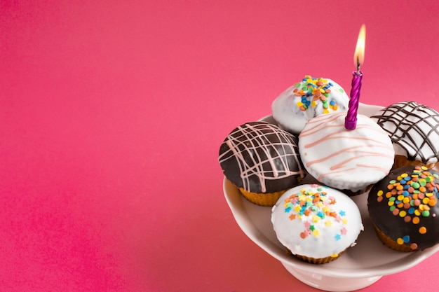 Decorated cupcakes on red table