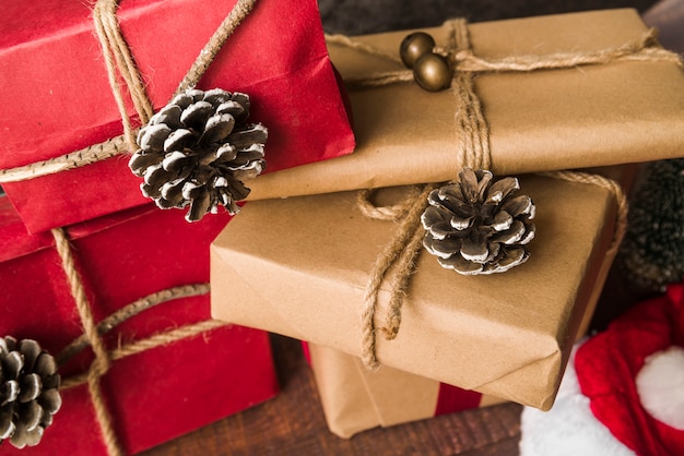 Decorated gift boxes near snags and Christmas hat