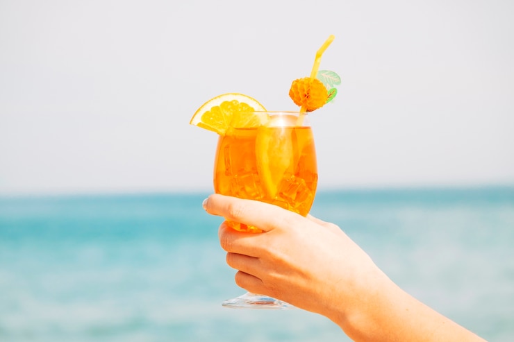 Free Photo decorated glass of amazing orange drink  in hand