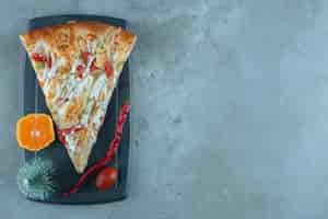 Free photo a decorated lunch serving of pizza on marble surface