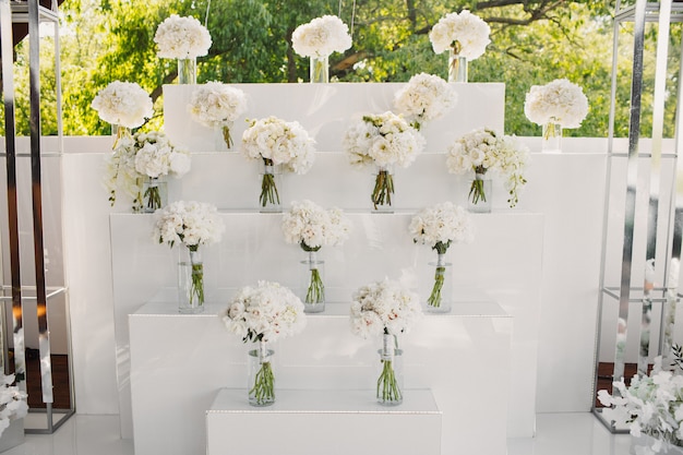 Decorated wall by white flowers bouquets