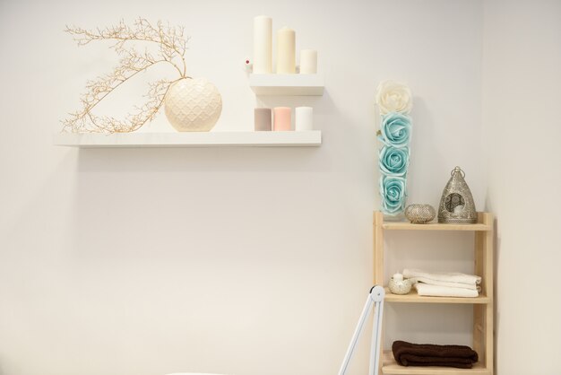 Decoration details in modern wellness center with flower vase and candles.