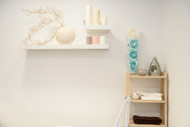 Decoration details in modern wellness center with flower vase and candles.