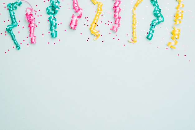 Decoration of streamers and confetti on blue background