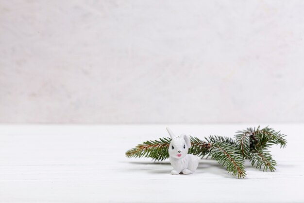 Decoration with fir tree twig and white rabbit