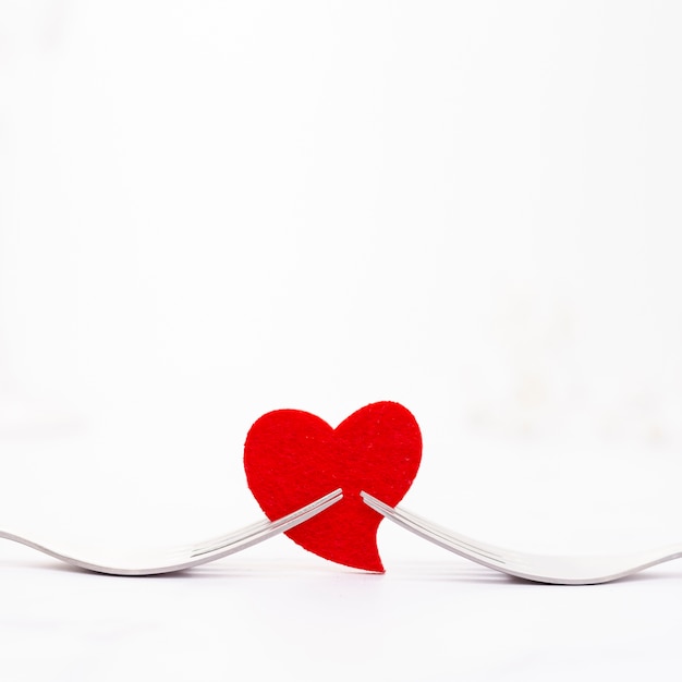 Decoration with forks holding a red heart