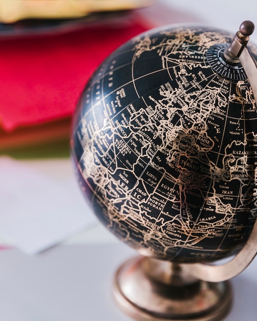 Decorative black and bronze globe on desk