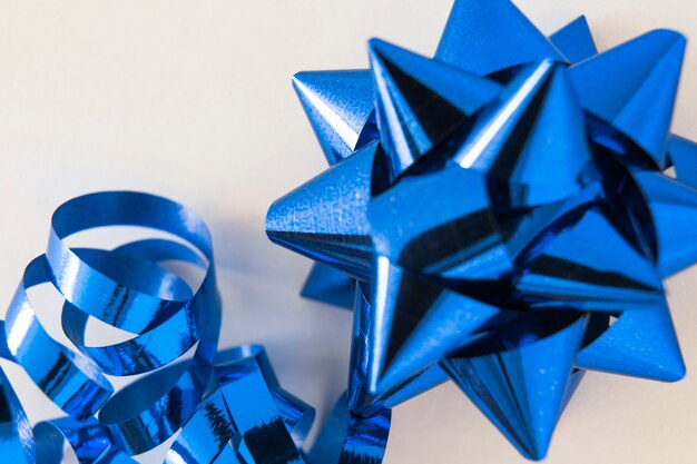 Decorative blue stain ribbon bow on white background