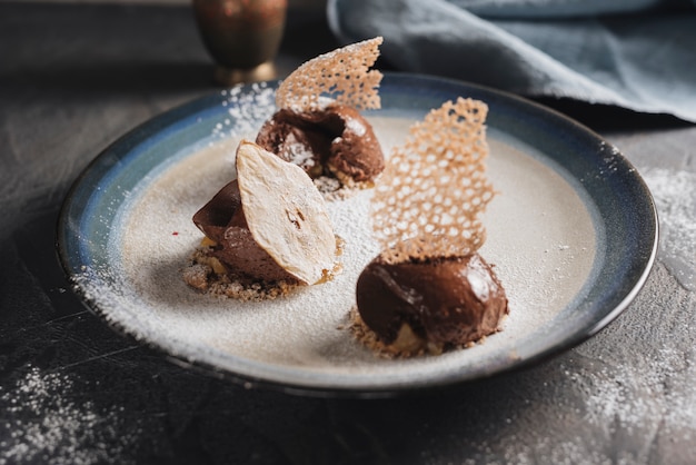 Decorative chocolate pastry on plate