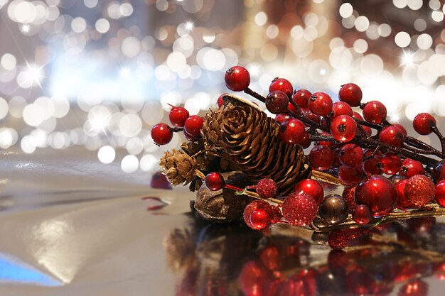 Decorative christmas background with berries and pine cones