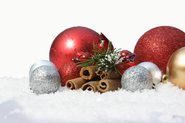 Decorative christmas baubles in snow 