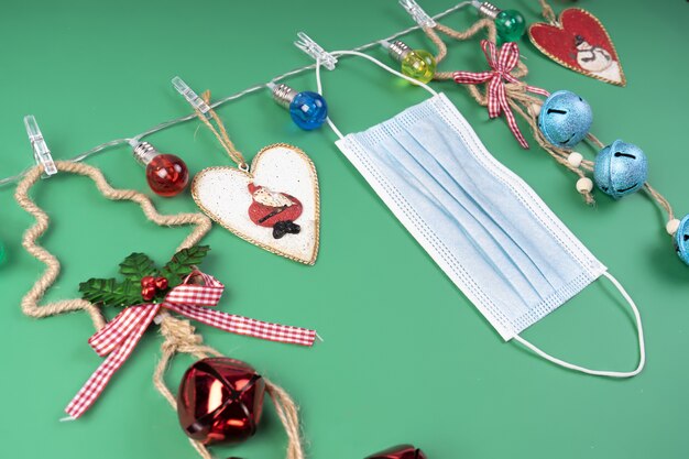 Decorative Christmas decorations in a garland of colored lights on a green background