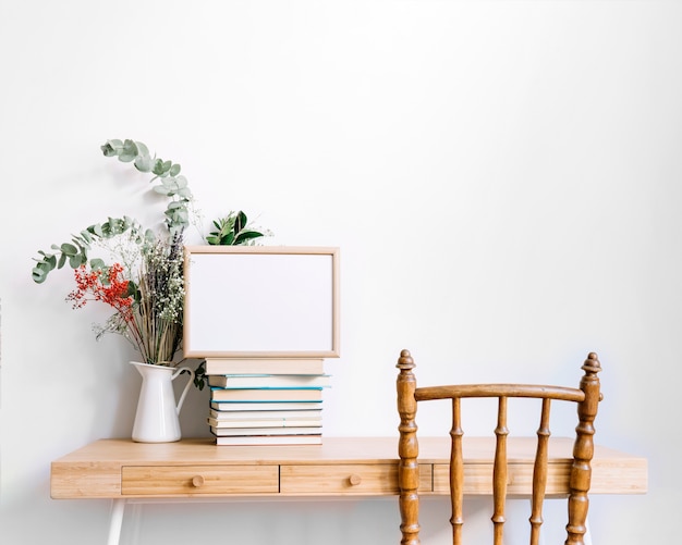 Decorative desk with books and plant