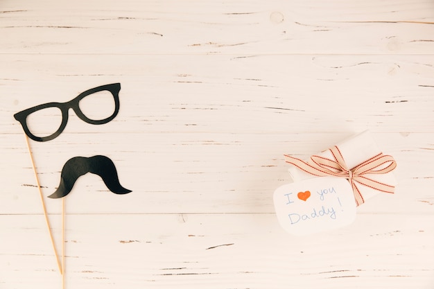 Decorative eyeglasses and moustache near present