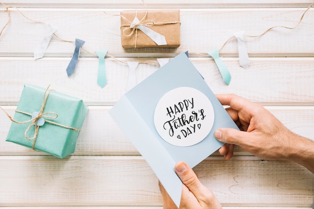 Free photo decorative fathers day composition with hands holding card