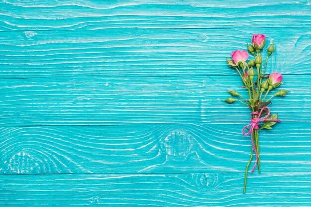 Decorative flowers on blue wooden surface
