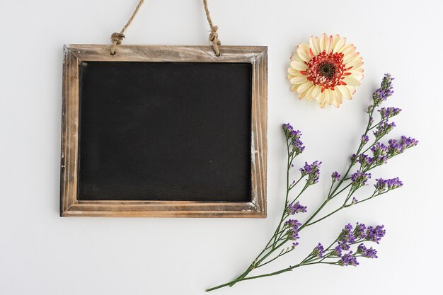 Decorative flowers next to slate