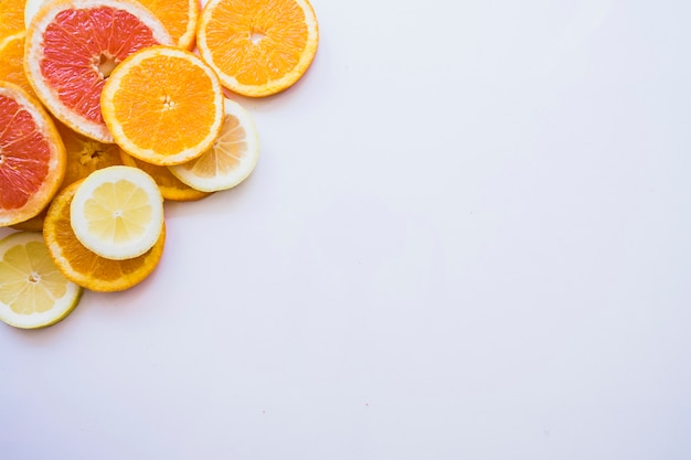 Decorative fruit slices on white surface