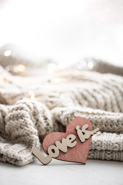 A decorative heart among cozy knitted items valentines day holiday concept