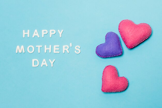 Decorative hearts near happy mothers day title