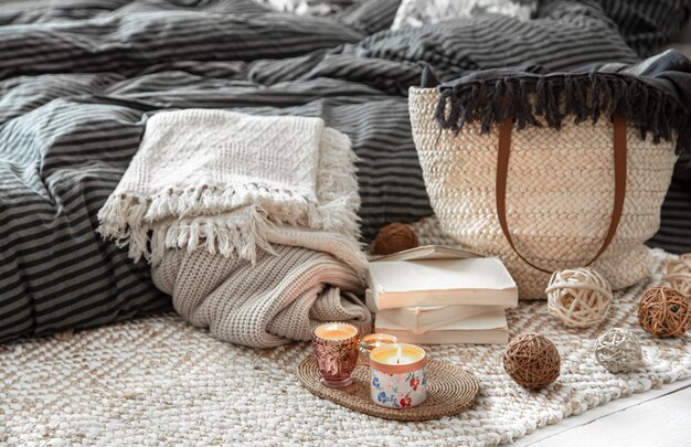 Decorative items in a cozy home interior. Wicker straw large bag, and decorative elements.