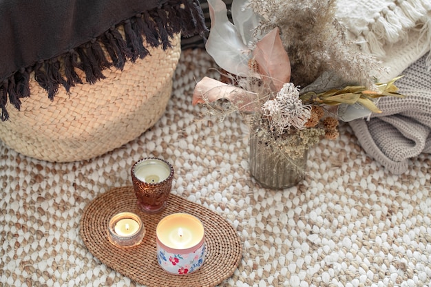 Decorative items in a cozy home interior. Wicker straw large bag, and decorative elements