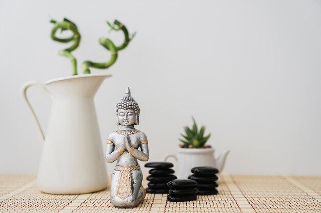 Decorative scene with bamboo and buddha figure