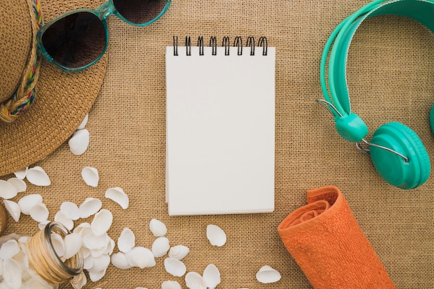 Free photo decorative summer elements with a blank notebook