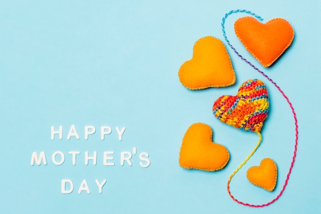 Decorative symbols of heart near happy mothers day inscription