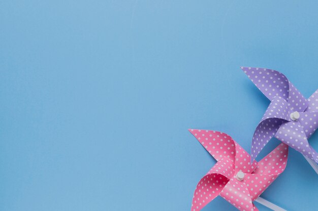 Decorative two polka dotted pinwheel on blue backdrop