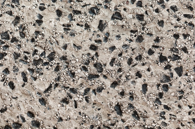 Decorative uneven cracked real stone and sand wall surface