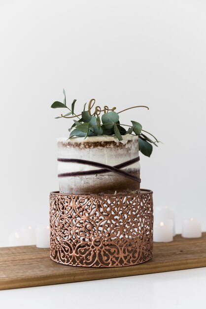 A decorative wedding cake with wedding cake on wooden table