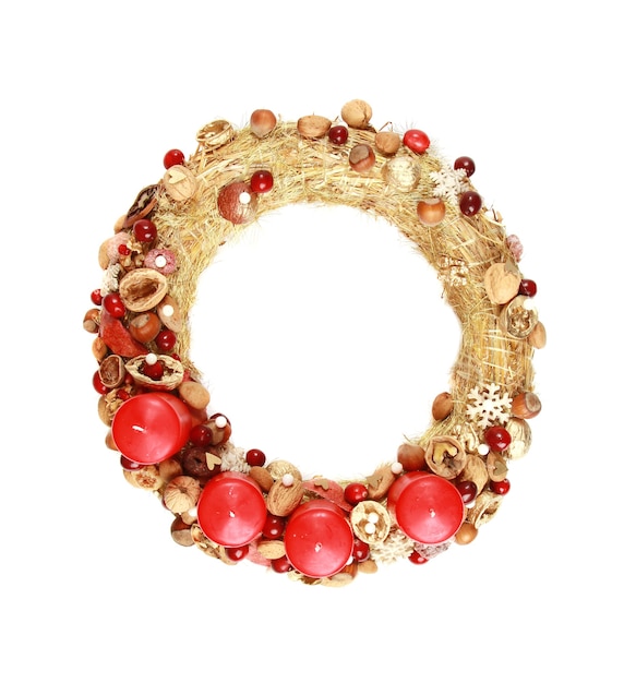 Decorative wreath with red Christmas candles isolated on white