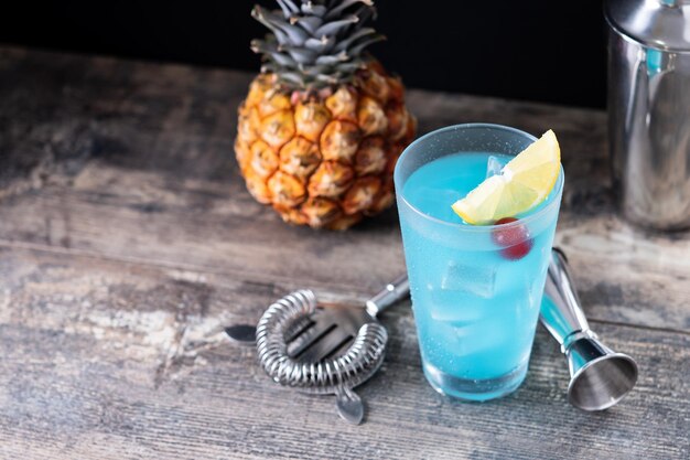 Deep blue sea martini cocktail on wooden table