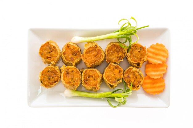 Deep fried crab meat roll in white plate