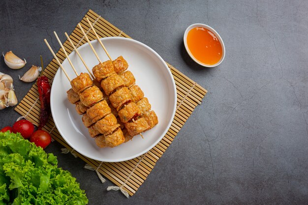 Deep fried fhicken roll on the dark surface.