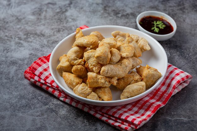 Deep fried fish ball on the dark surface.