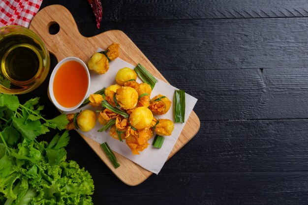 Deep fried wonton on the dark surface.