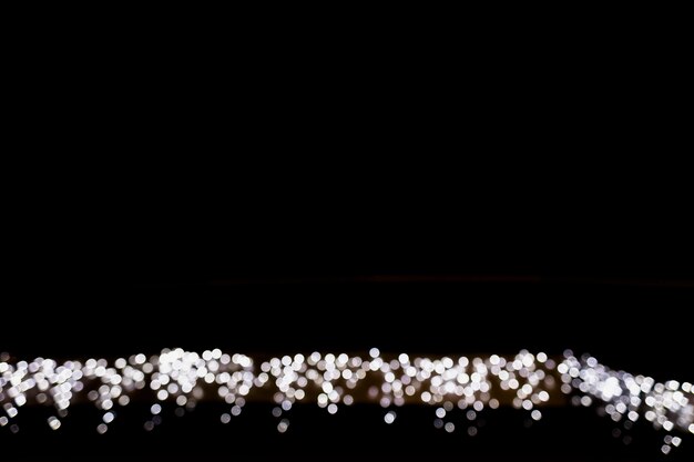 defocused bokeh light decoration on black background with space for writing the text