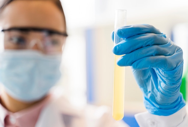 Defocused female scientist holding lab substance