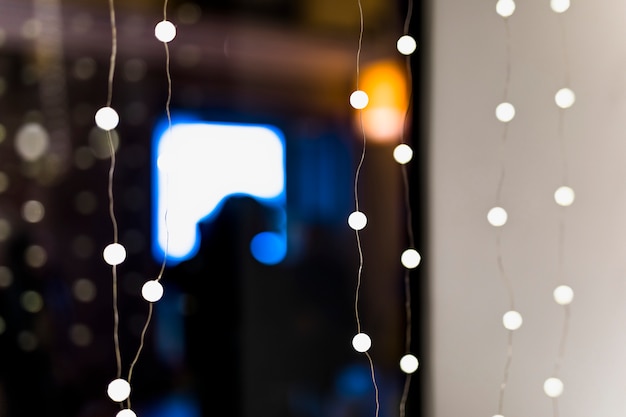 Defocused illuminated fairy light in the room