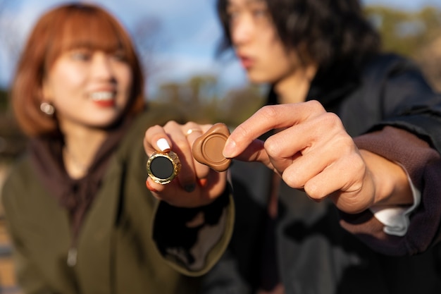 Defocused japanese couple holding chocolate sweets outdoors