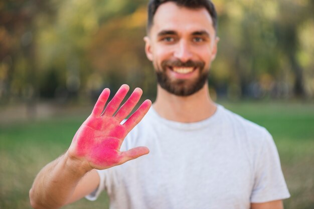 Defocused man holding colored hand