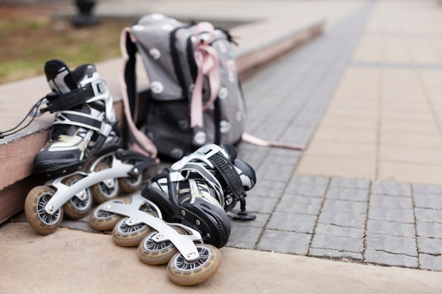 Defocused roller blades on pavement with backpack