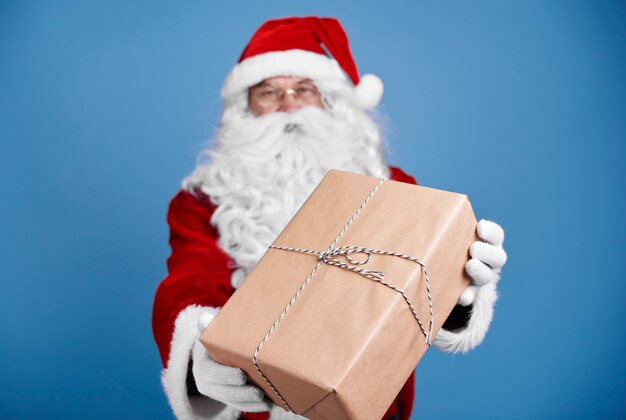 Defocused santa claus giving christmas presents