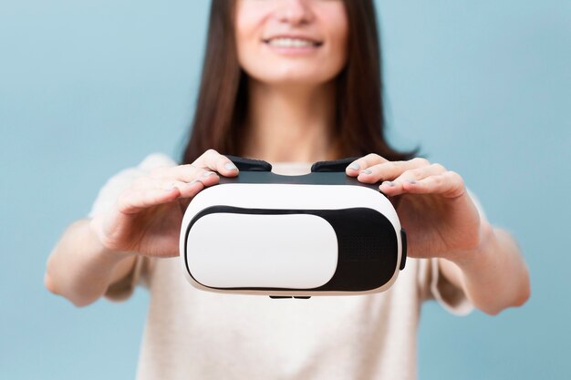 Defocused woman holding virtual reality headset