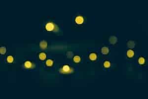 Free photo defocused yellow bokeh lights on dark background