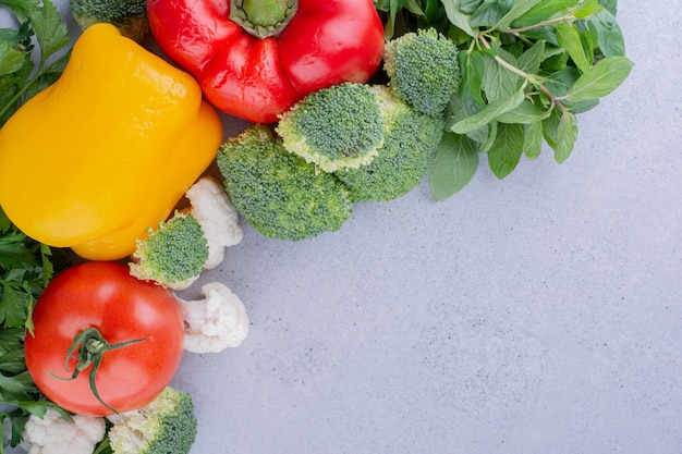 Delectable assortment of vegetables and greens on marble background. High quality photo